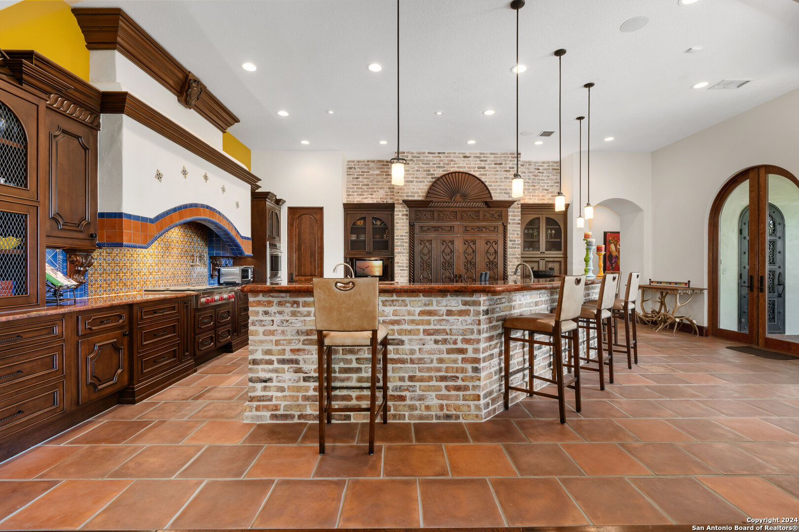 211 Augusta Boerne, TX 78006 - Photo 26 of 59 a open kitchen with stainless steel appliances kitchen island granite countertop a stove a sink a dining table and chairs