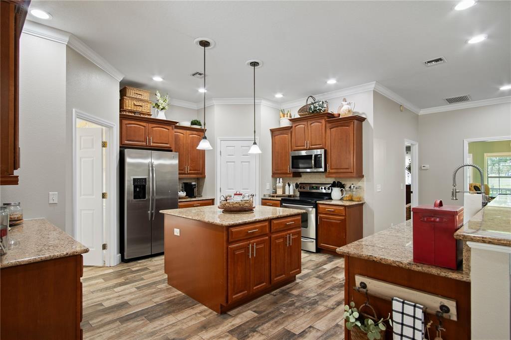 9045 Lake Hatchineha Road Kissimmee, FL 34759 - Photo 18 of 47 a kitchen with a sink stove and refrigerator