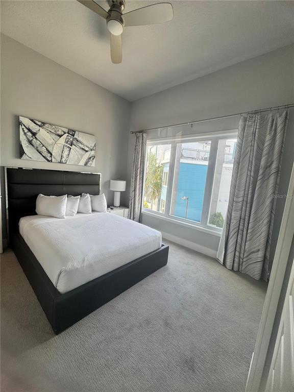 7770 Sandy Ridge Drive, Unit 210 Reunion, FL 34747 - Photo 24 of 42 a bedroom with a bed and a large window