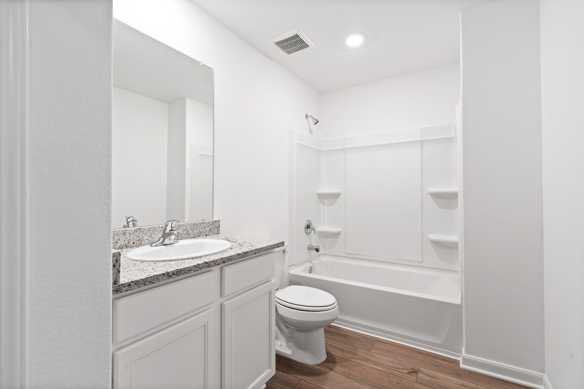 409 Silent Meadow Run Maxwell, TX 78656 - Photo 10 of 10 Bathroom with shower / bathtub combination, dark wood finished floors, and vanity