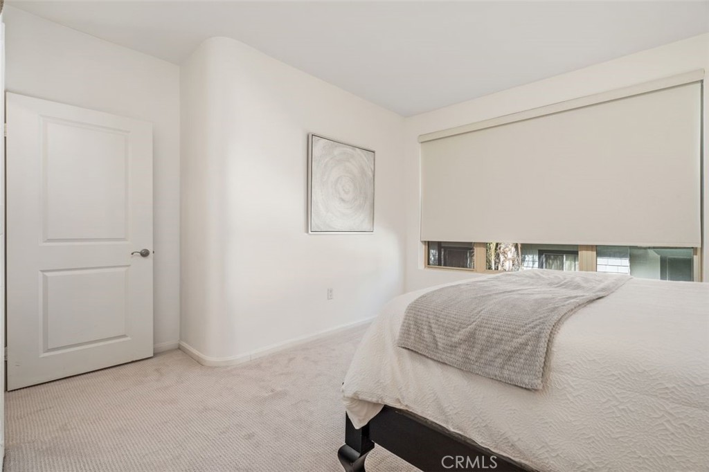 128 North Oak Knoll Avenue, Unit 317 Pasadena, CA 91101 - Photo 14 of 22 a bedroom with a bed and a cabinets