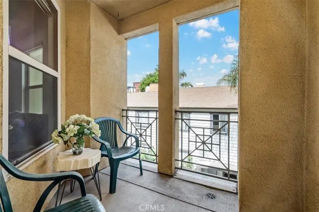 a dining room with furniture a potted plant and windows