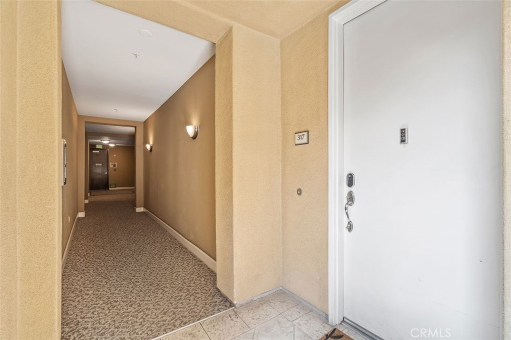 128 North Oak Knoll Avenue, Unit 317 Pasadena, CA 91101 - Photo 19 of 22 a view of a hallway with wooden shelves