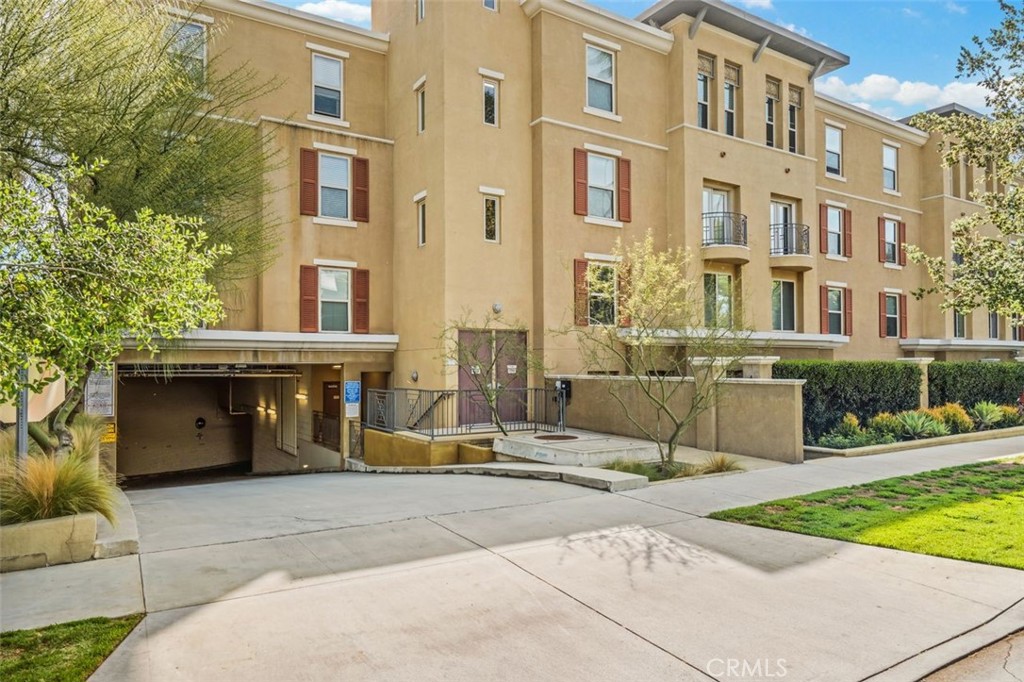 128 North Oak Knoll Avenue, Unit 317 Pasadena, CA 91101 - Photo 20 of 22 a front view of a building with garden and parking