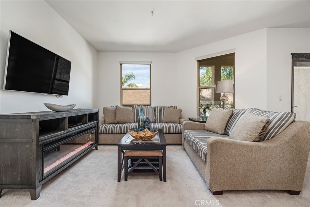 128 North Oak Knoll Avenue, Unit 317 Pasadena, CA 91101 - Photo 5 of 22 a living room with furniture and a flat screen tv