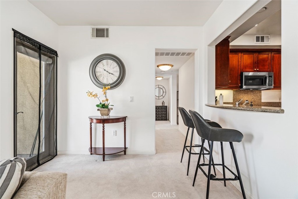 128 North Oak Knoll Avenue, Unit 317 Pasadena, CA 91101 - Photo 6 of 22 a view of a hallway with furniture and a mirror