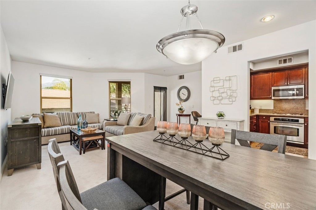 128 North Oak Knoll Avenue, Unit 317 Pasadena, CA 91101 - Photo 9 of 22 a view of a dining room with furniture window and outside view
