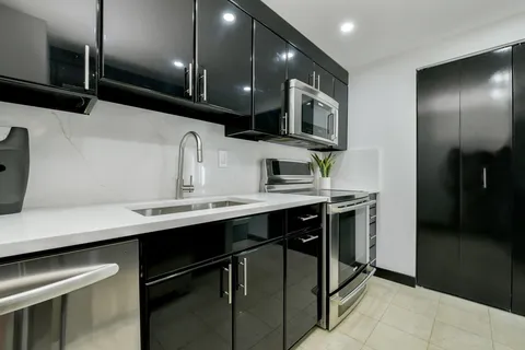a kitchen with stainless steel appliances a sink and a refrigerator