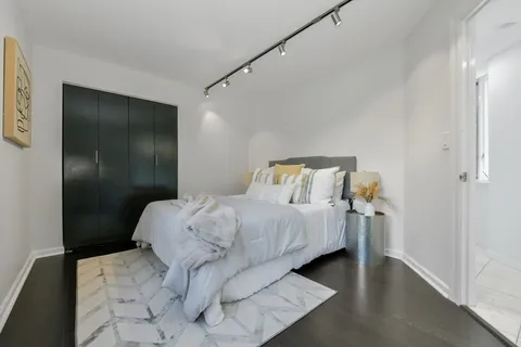 a bed sitting in a bedroom next to a bathroom