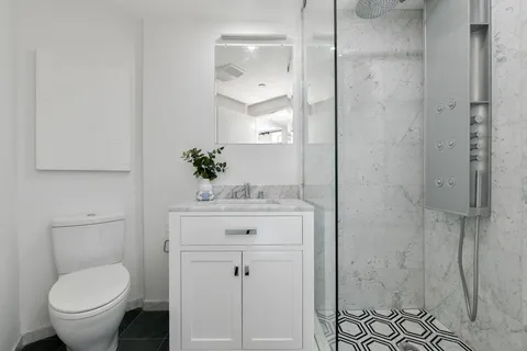 a bathroom with a sink toilet and shower