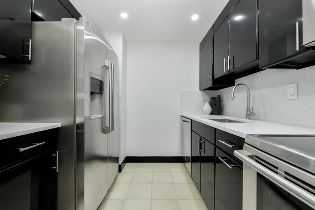 a kitchen with a sink appliances and cabinets