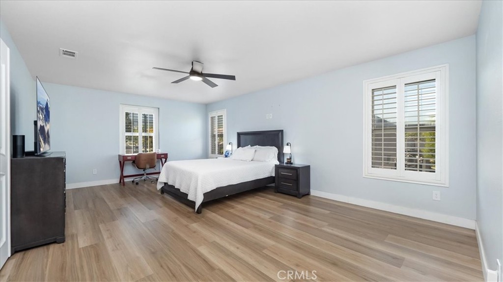 321 Adirondack Drive Corona, CA 92881 - Photo 9 of 22 a bedroom with a large bed and a chandelier