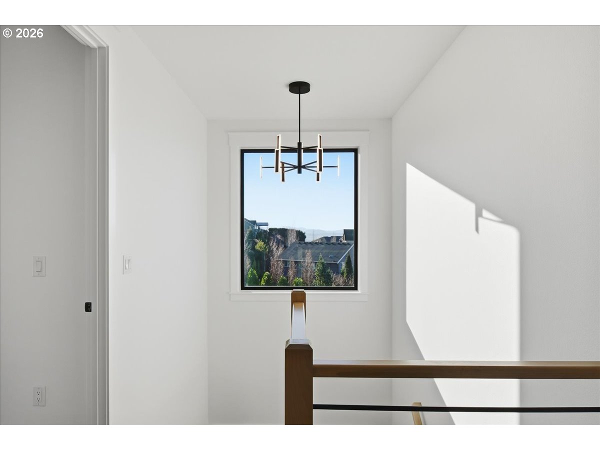 1597 Northwest Goodwin Street Camas, WA 98607 - Photo 21 of 44 a view of a hallway with wooden floor and a large window