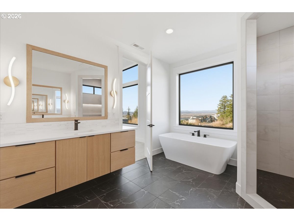 1597 Northwest Goodwin Street Camas, WA 98607 - Photo 28 of 44 a bathroom with a sink mirror and a bathtub