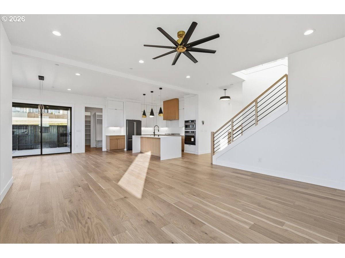 1597 Northwest Goodwin Street Camas, WA 98607 - Photo 7 of 44 a view of a livingroom with a ceiling fan and wooden floor