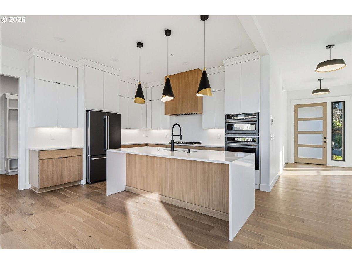 1597 Northwest Goodwin Street Camas, WA 98607 - Photo 10 of 44 a kitchen with kitchen island granite countertop a sink counter top space and stainless steel appliances