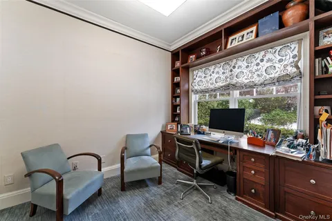 a reading room with furniture and a flat screen tv