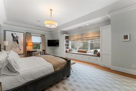 a bedroom with a large bed and a large window