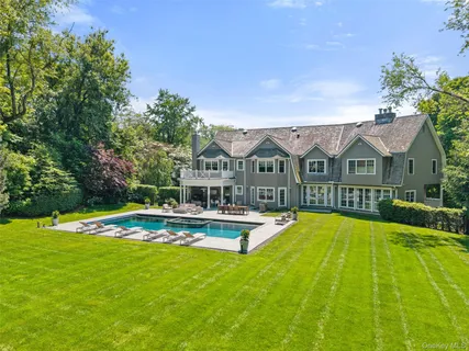 a view of a house with swimming pool and porch with furniture