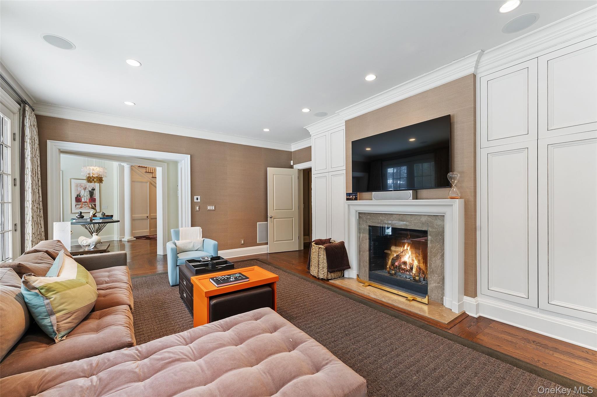 35 Eton Road Scarsdale, NY 10583 - Photo 8 of 43 Family room with fireplace leads to kitchen and french doors to the backyard