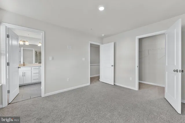 an empty room with a bathroom and sink