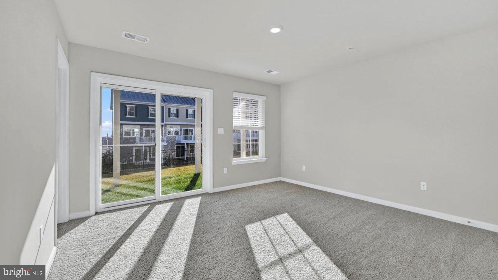 5018 Silver Oak Drive Rosedale, MD 21237 - Photo 3 of 19 an empty room with floor to ceiling windows and carpet
