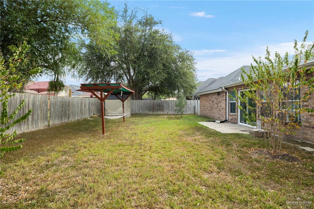 604 Hidden Trace Weslaco, TX 78599 - Photo 15 of 20 a backyard of a house with table and chairs