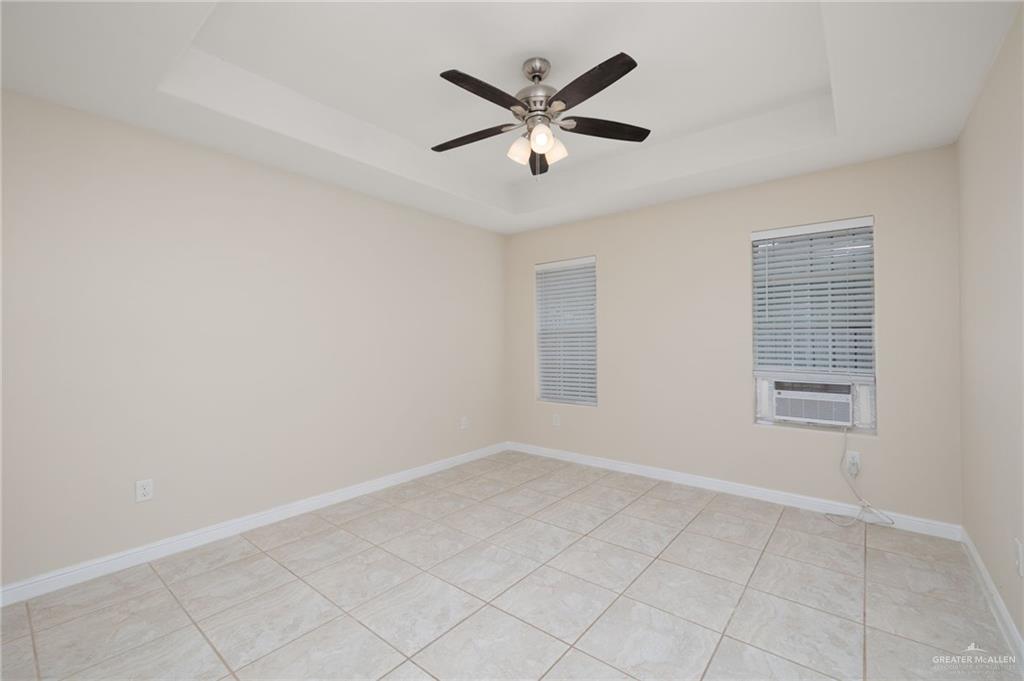 604 Hidden Trace Weslaco, TX 78599 - Photo 8 of 20 wooden floor in an empty room with a window