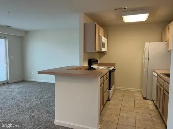 a kitchen with a sink cabinets and appliances