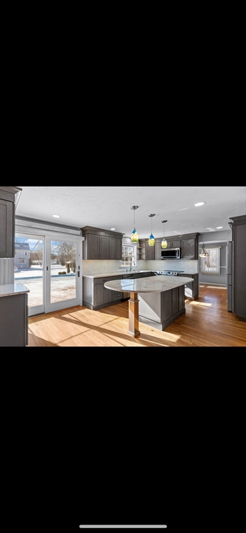 5 Vincent Road Attleboro, MA 02703 - Photo 9 of 32 a kitchen with stainless steel appliances a sink and a stove
