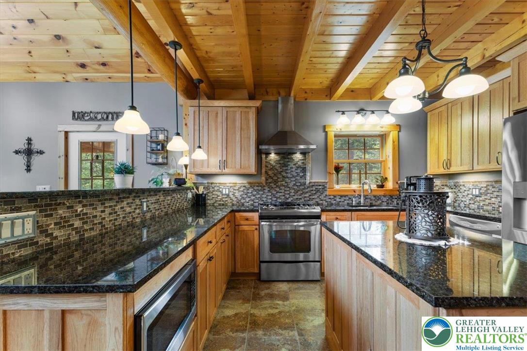 207 West Douglasville Road Nazareth, PA 18064 - Photo 34 of 73 a kitchen with stainless steel appliances granite countertop a sink a stove and cabinets