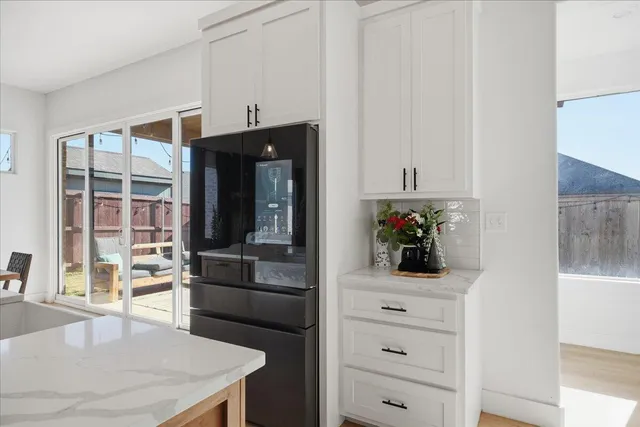 a kitchen with a refrigerator and a stove top oven