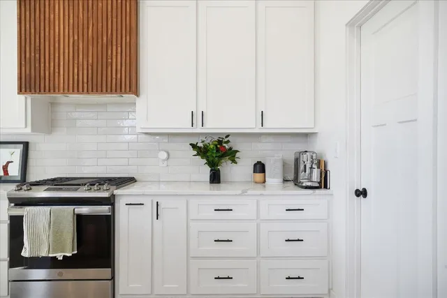a kitchen with cabinets and appliances
