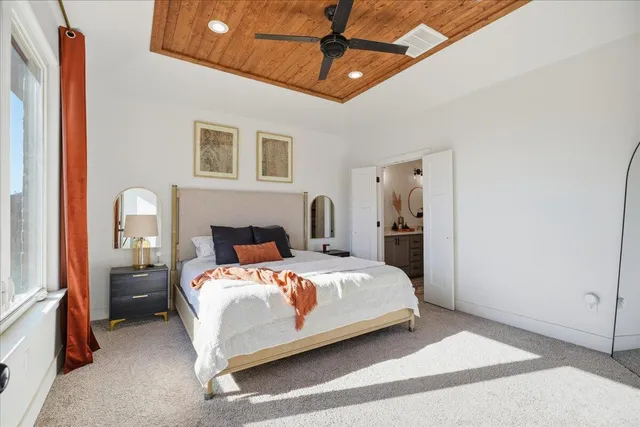 a bedroom with a bed wooden floor and window