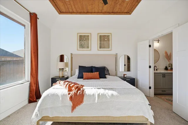 a bedroom with a large bed and a large window