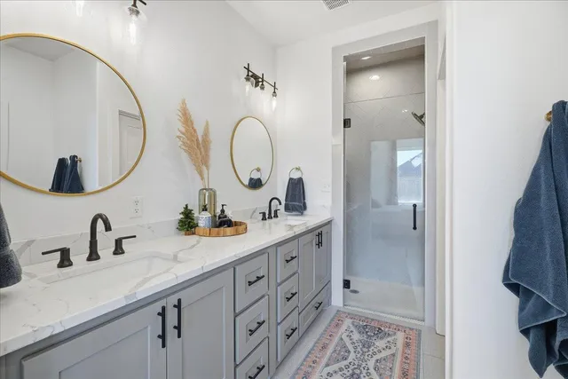 a bathroom with a double vanity sink and a mirror