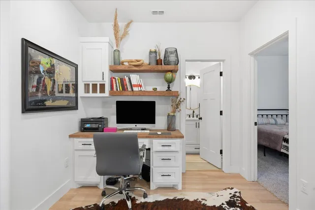 a view of a workspace with a bookshelf