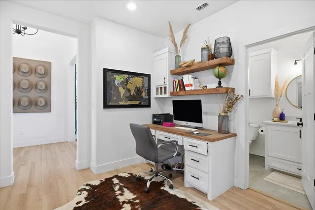 a view of a workspace with furniture and a flat screen tv
