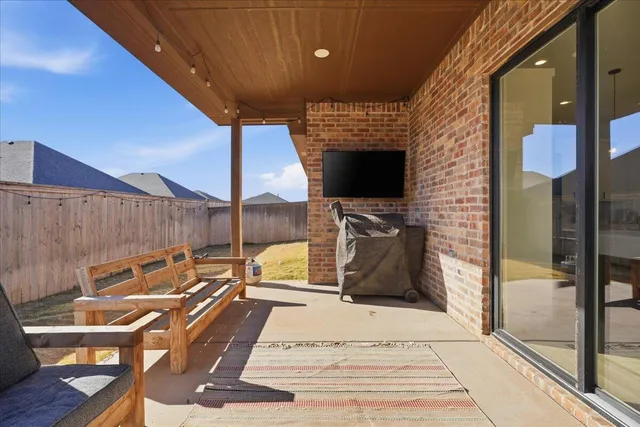 a view of a patio with a table and chairs