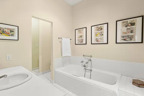 a white bath tub sitting next to a white sink