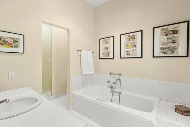 a white bath tub sitting next to a white sink