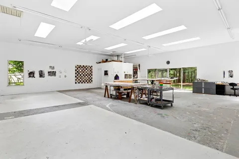 a large room with lots of furniture and a large window