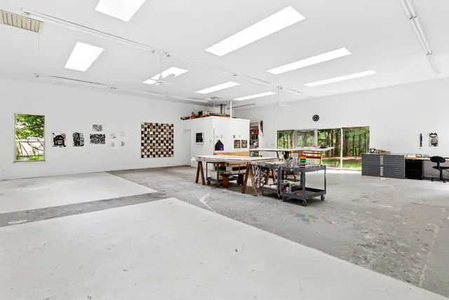 a large room with lots of furniture and a large window