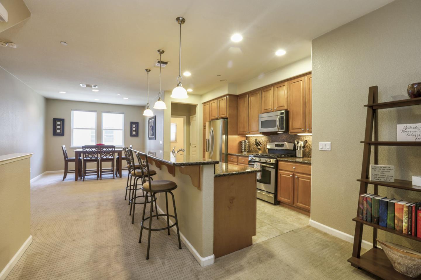 907 Rancho Place San Jose, CA 95126 - Photo 15 of 50 a kitchen with stainless steel appliances kitchen island granite countertop dining table chairs and a refrigerator