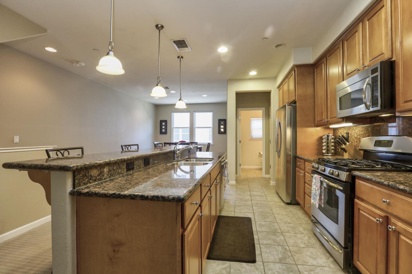 907 Rancho Place San Jose, CA 95126 - Photo 16 of 50 a kitchen with stainless steel appliances granite countertop a sink a stove and a wooden floors