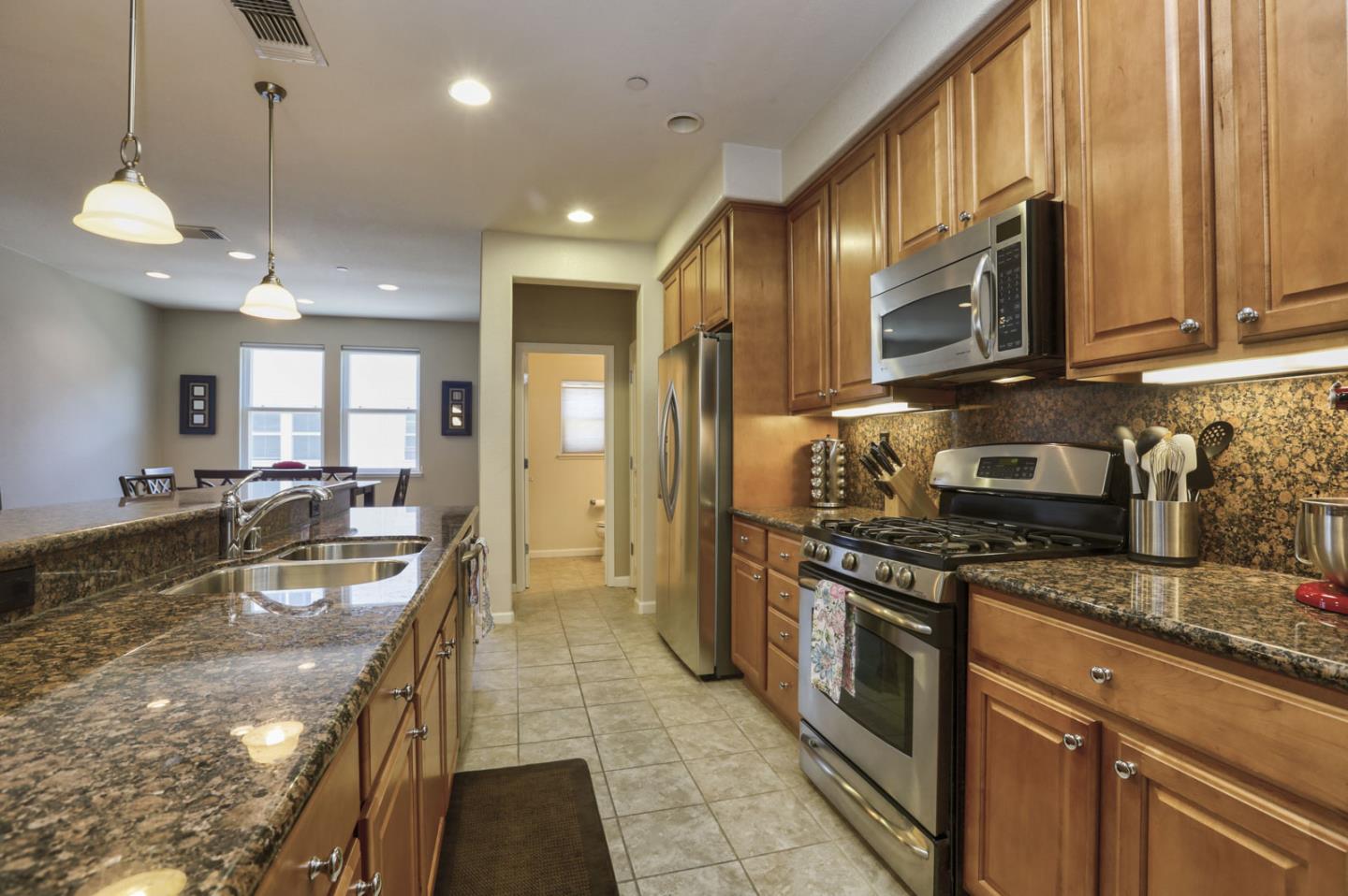 907 Rancho Place San Jose, CA 95126 - Photo 17 of 50 a kitchen with stainless steel appliances granite countertop a stove a sink and a refrigerator