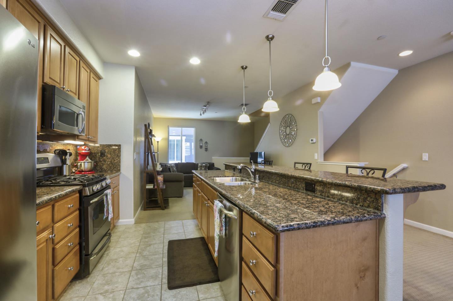 907 Rancho Place San Jose, CA 95126 - Photo 21 of 50 a kitchen with a stove a refrigerator and a dining table