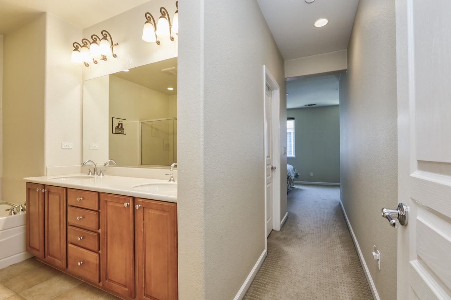 907 Rancho Place San Jose, CA 95126 - Photo 33 of 50 a en suite bathroom with a granite countertop sink and a mirror