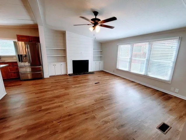 wooden floor in an empty room with a window