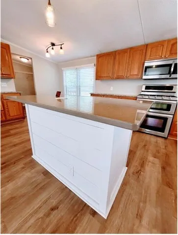 a kitchen with stainless steel appliances a stove a microwave and a refrigerator